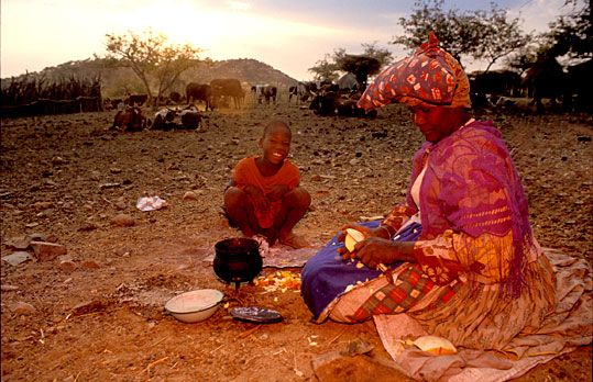 Herero woman cooking breakfast