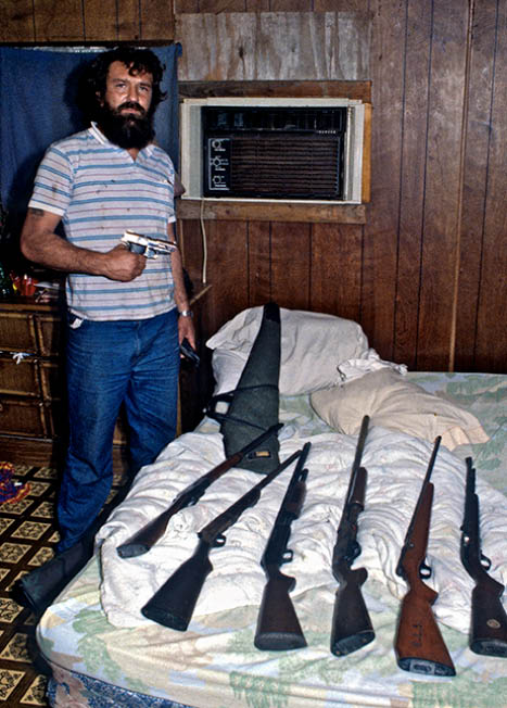 John showing me some of his gun collection on children's bed