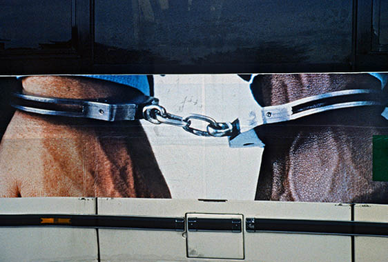 Hands cuffed together Beneton Ad