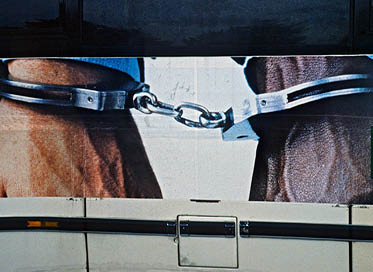 Hands cuffed together Beneton Ad