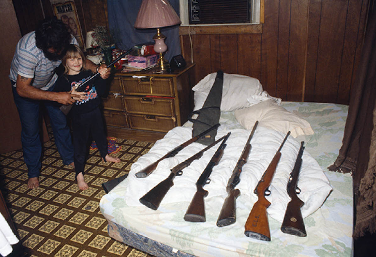 John teaching 7 year old Natasha how to use guns