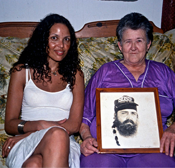 Rose showing her picture of her son Sammy in prison to Rikke Marott