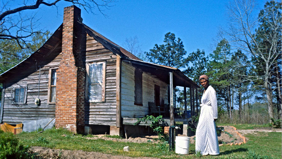 Mary with her new shack and still untilled piece of land in 1978