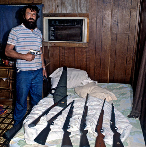 John showing me some of his gun collection on children's bed
