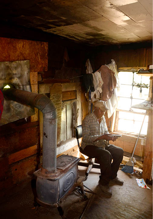 2012 - Old man with cell phone in his shack, Perry County, AL 