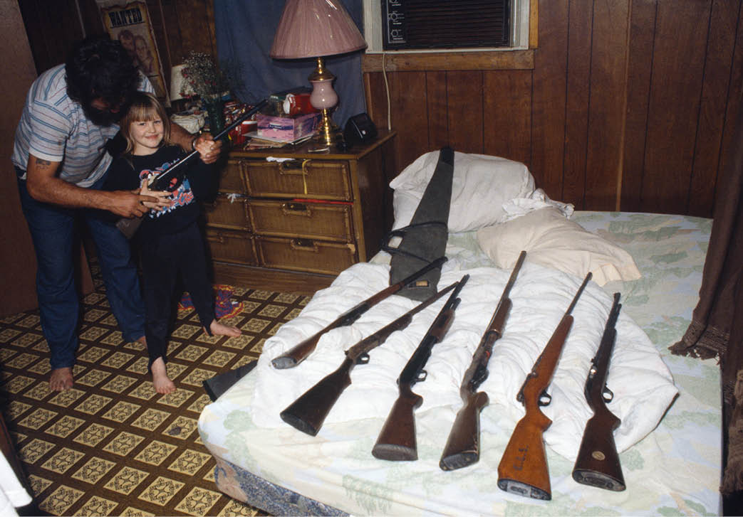 John teaching 7 year old Natasha how to use guns