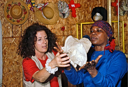 Mary showing Anita Roddick the hats and quilts she makes 1994  