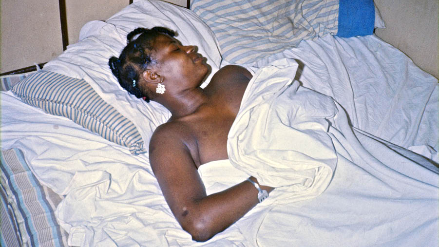 Mary at night in her shack on the forest backroads in Bullock County, 1974 
