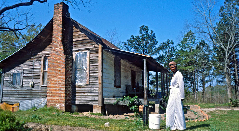 Mary with her new shack and still untilled piece of land in 1978