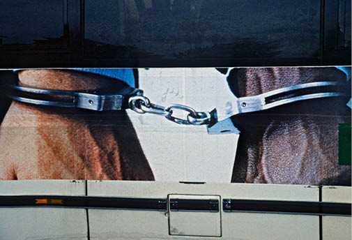 Hands cuffed together Beneton Ad