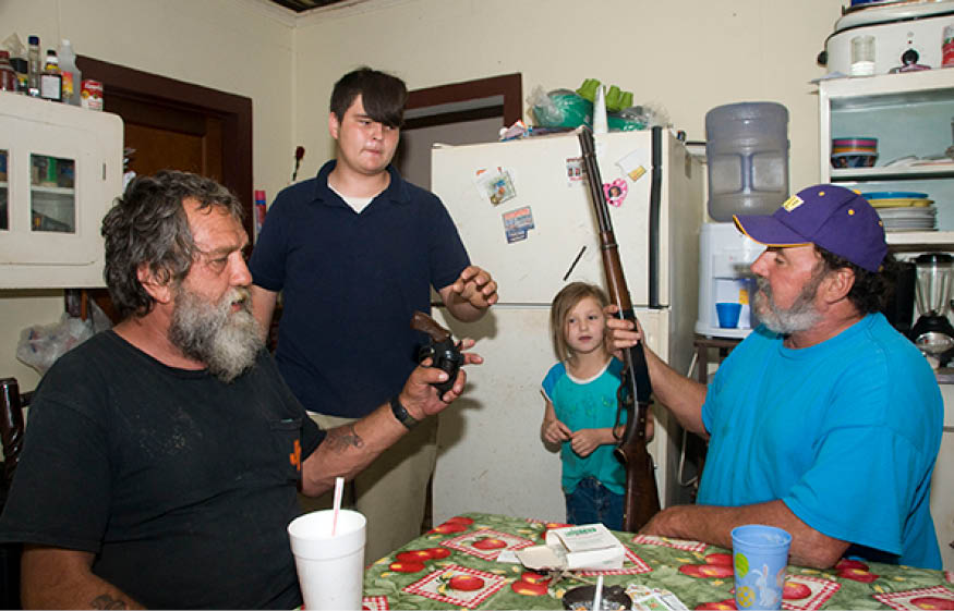 John with his stepson and grandchild Connie showing the guns he used for the killing the night before